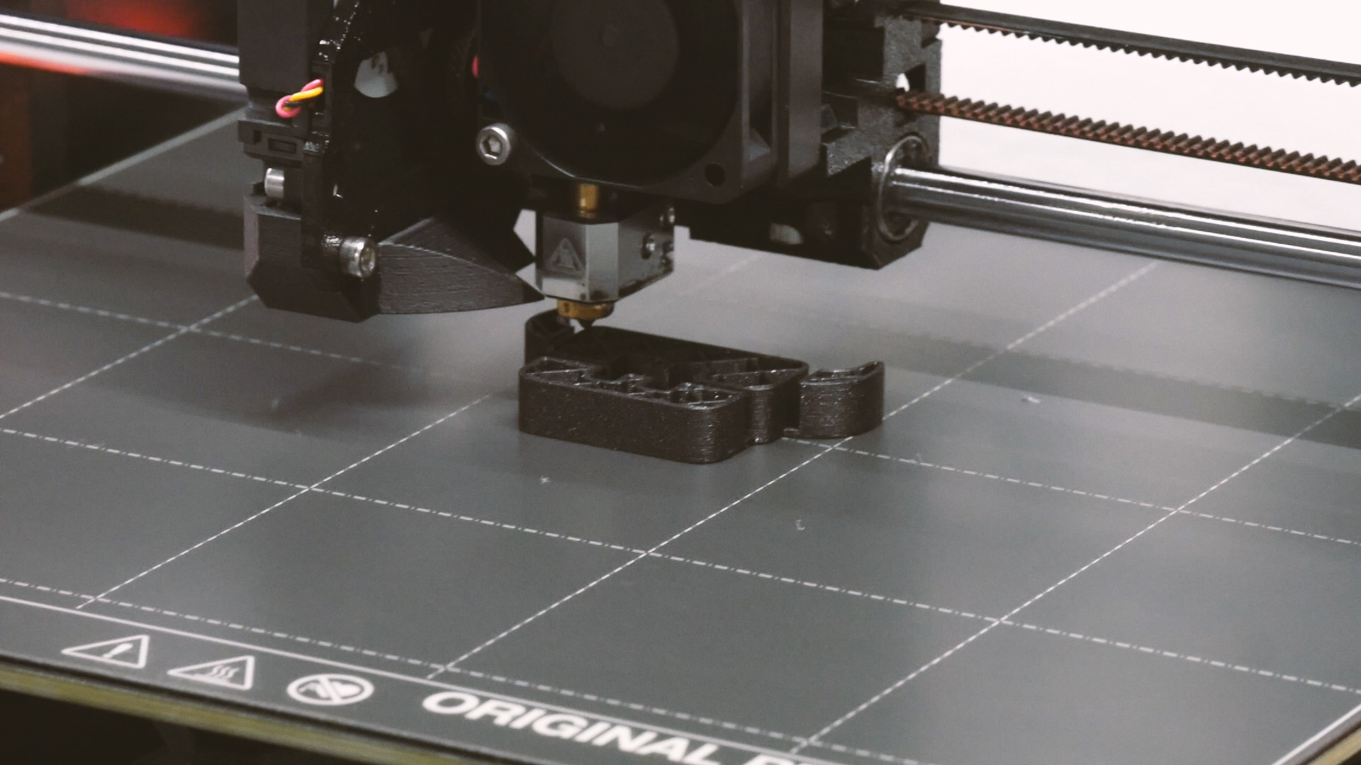 Close-up of a 3D printer printing a prototype component