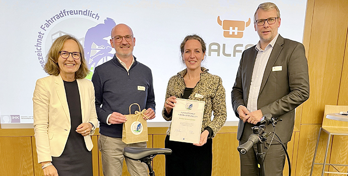 Halfar team with award as bike-friendly employer and bicycle