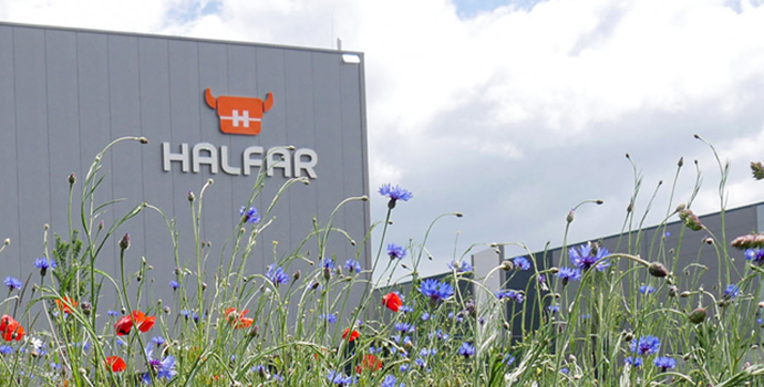 Halfar warehouse building with flower bed in the foreground and Halfar logo on the facade