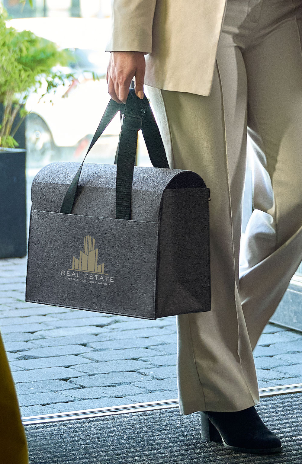 Felt laptop organizer as office to go, carried by person on the move