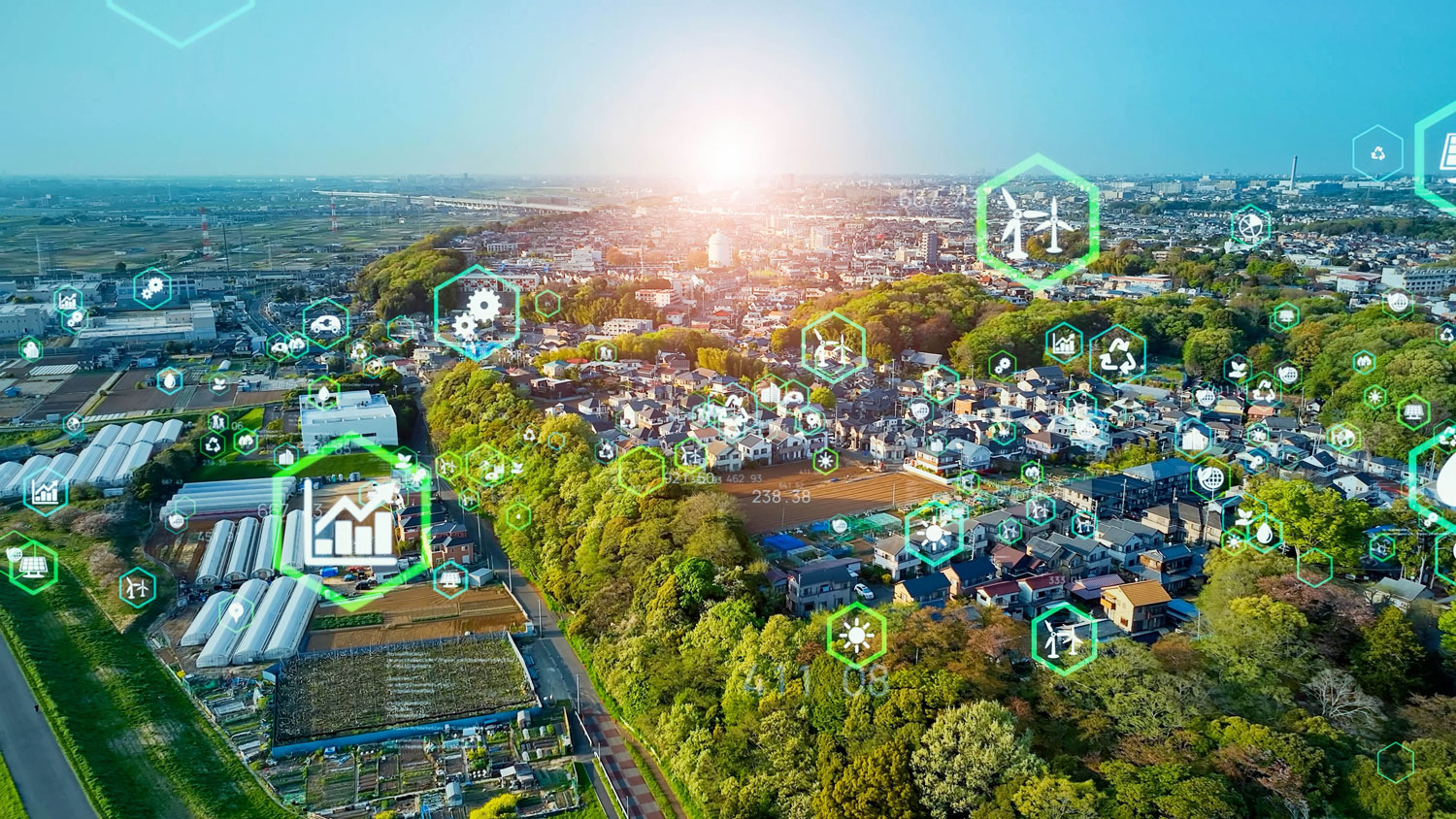 A bird's-eye view of a city with green spaces and symbols of sustainability