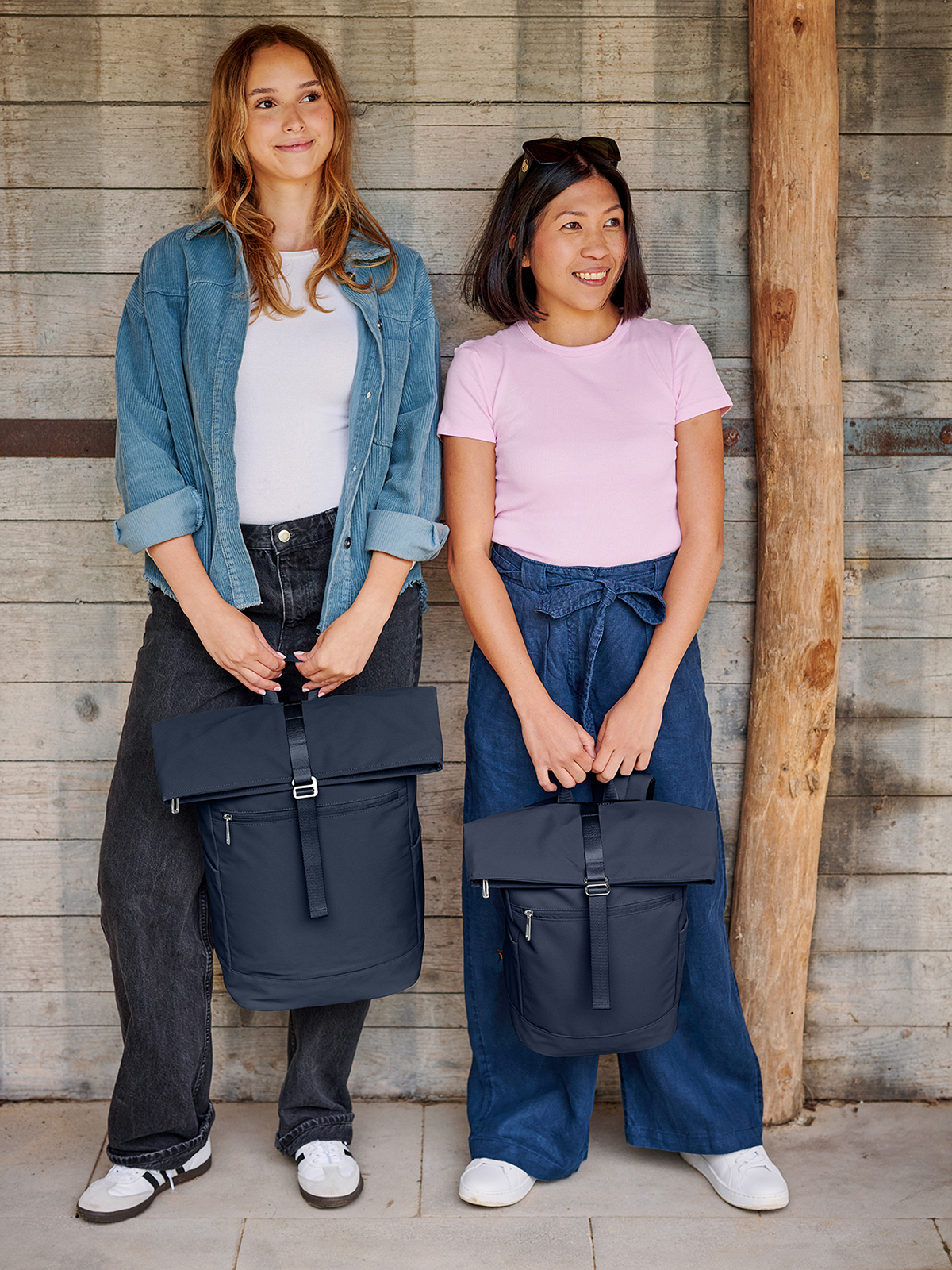 laptop backpack STAR and backpack STAR S navy held by models