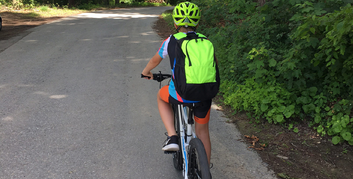Cyclist with bright neon bags for better visibility