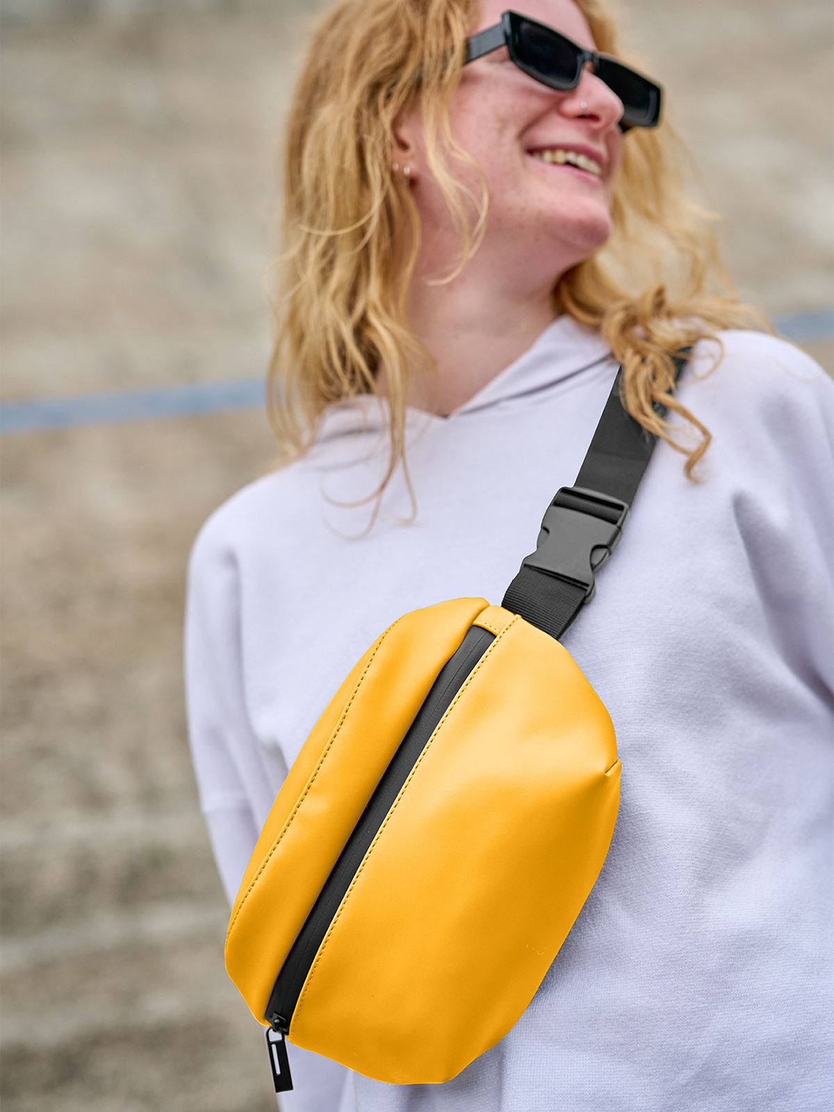 waist bag PURE yellow featuring a model