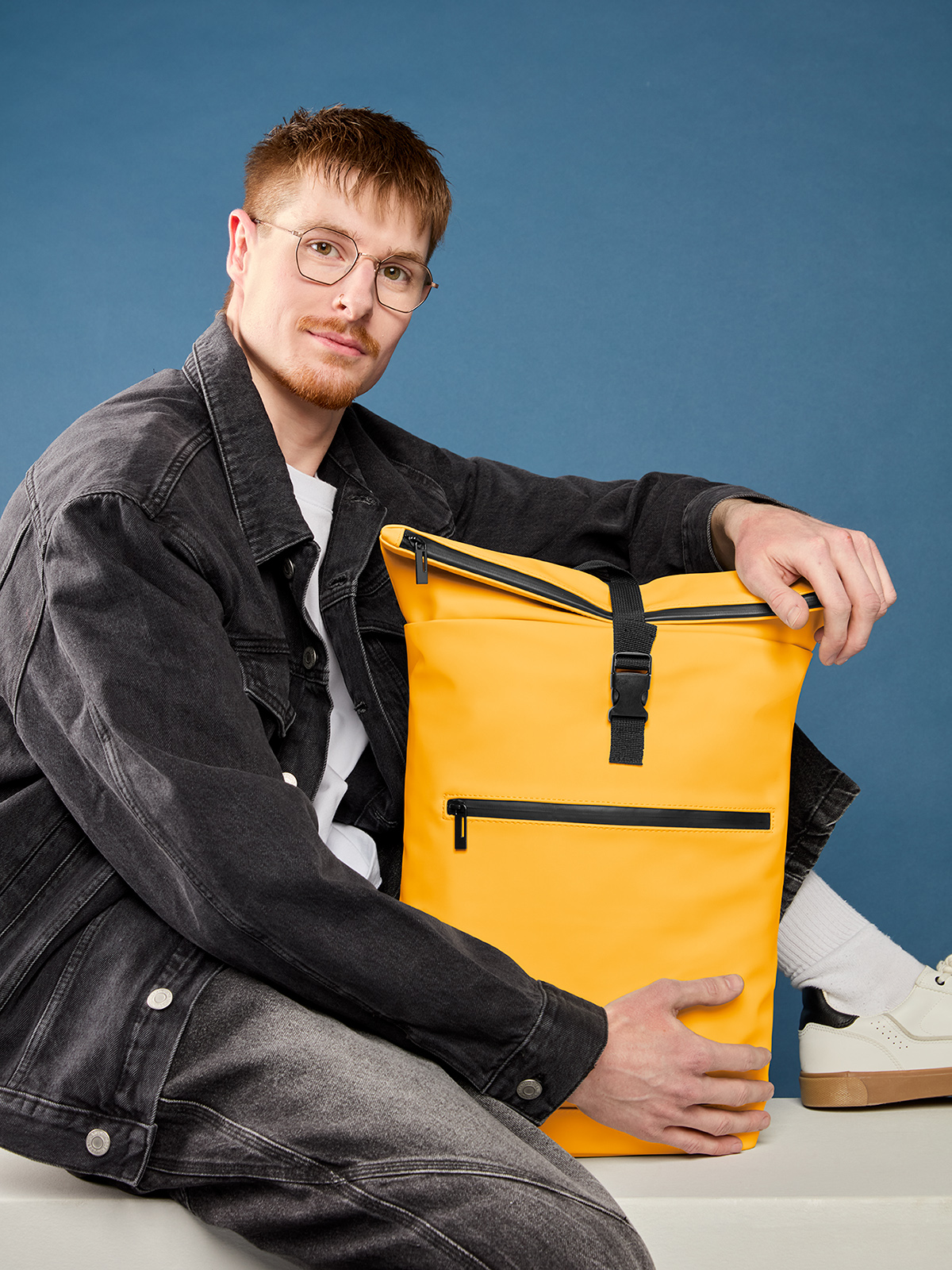 laptop backpack PURE in yellow, shown with model